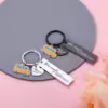 Rose gold metal keychain engraved with "You make a difference," featuring school bus and "Thank you" charms.