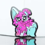 A whimsical pink and blue cat pin adorned with stars, showcasing a playful and colorful design.