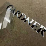 A metal sticker displaying the word "gardner" on a piece of paper, emphasizing a clean and modern design.
