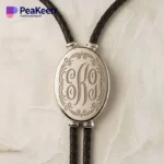 Silver monogrammed necklace with a leather cord, combining classic elegance with a contemporary bolo tie style.