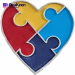 Heart-shaped puzzle piece with four colorful segments, symbolizing autism awareness and inclusivity.