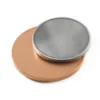 Round metal coaster featuring a copper top and a brass coin design.